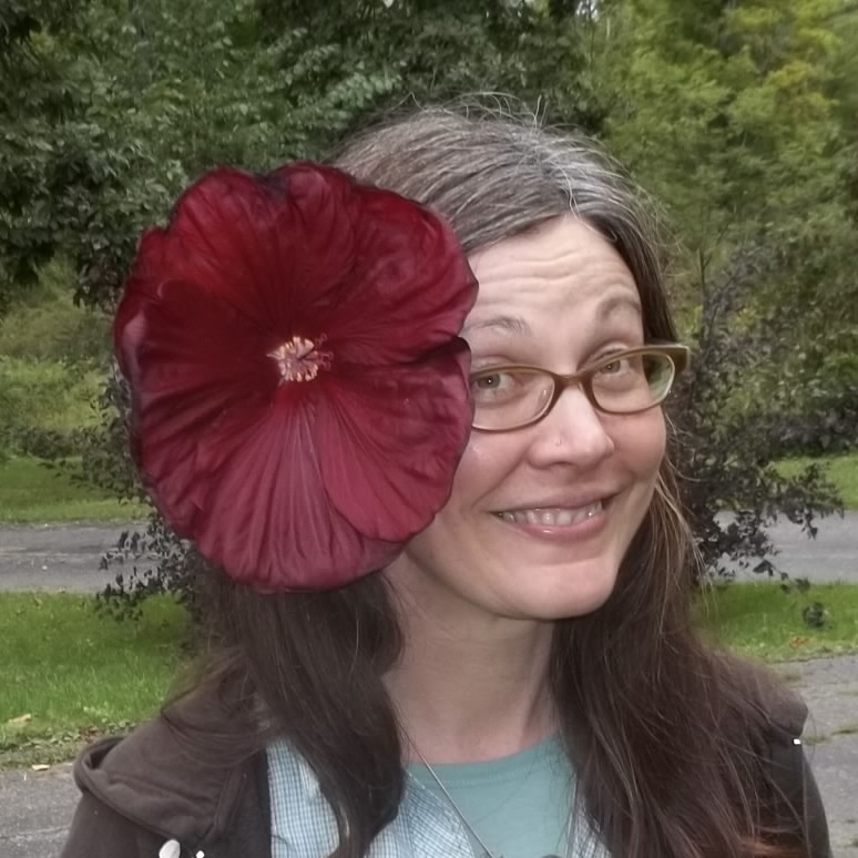 Leah Wolfe with a large flower tucked behind her ear.